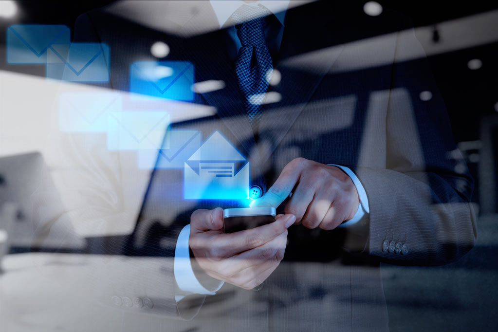 Individual sending an email using his smartphone