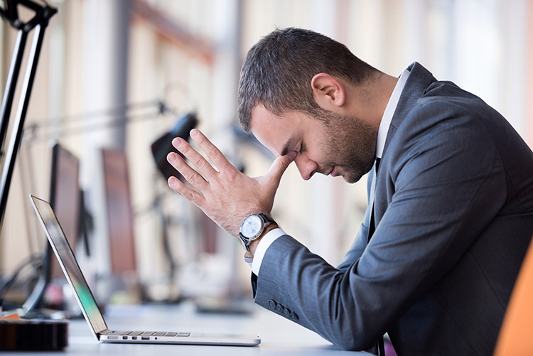 An attorney working on a problem with his laptop